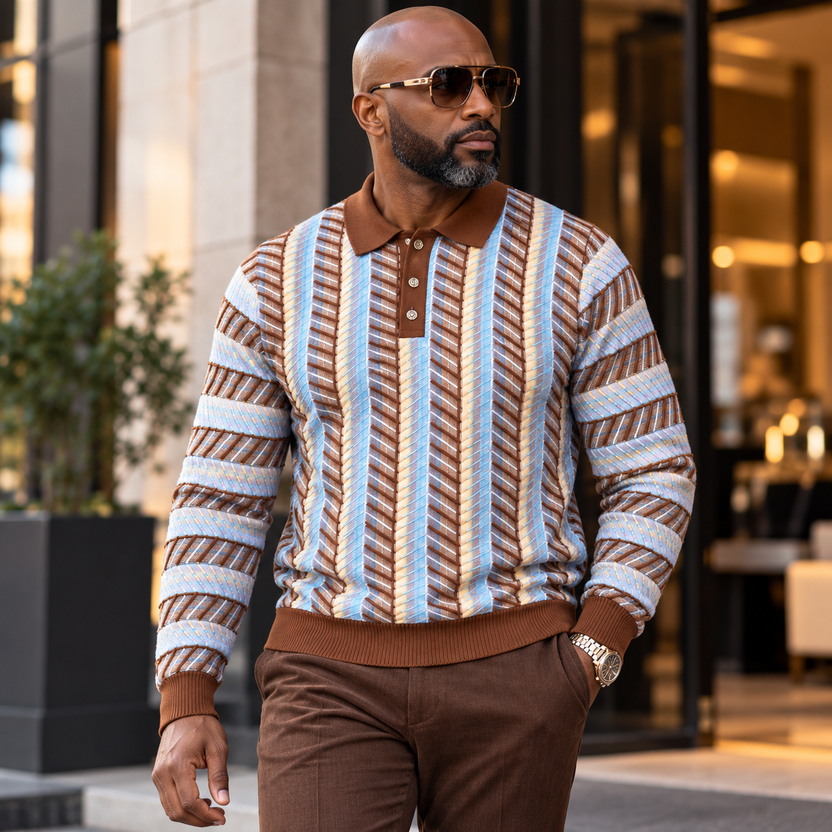 suit-yourself-menswear brown polo sweater with blue and cream chevron stripes worn by a man with sunglasses
