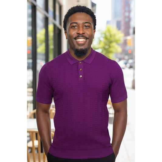 Man wearing a purple polo shirt standing outdoors with blurred background