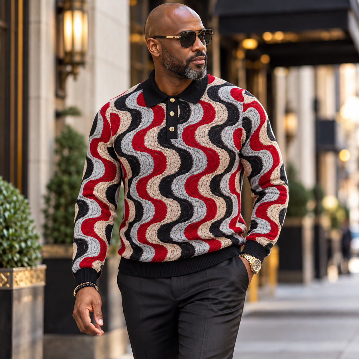 suit-yourself-menswear model wearing a black and burgundy swirl pattern knit polo sweater with gold button details
