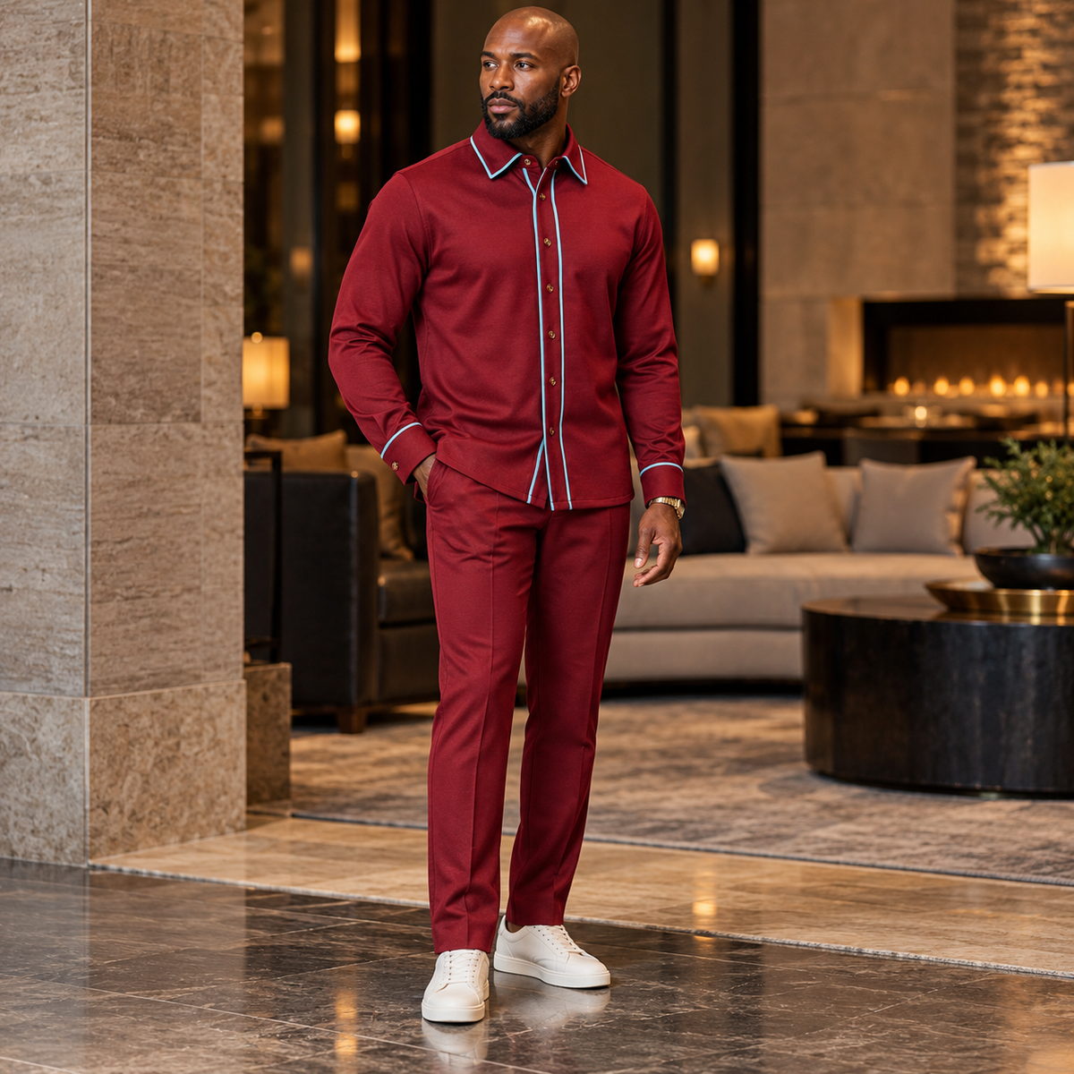 Model wearing a Suit Yourself Menswear burgundy two-piece casual set with light-blue contrast piping and white sneakers.