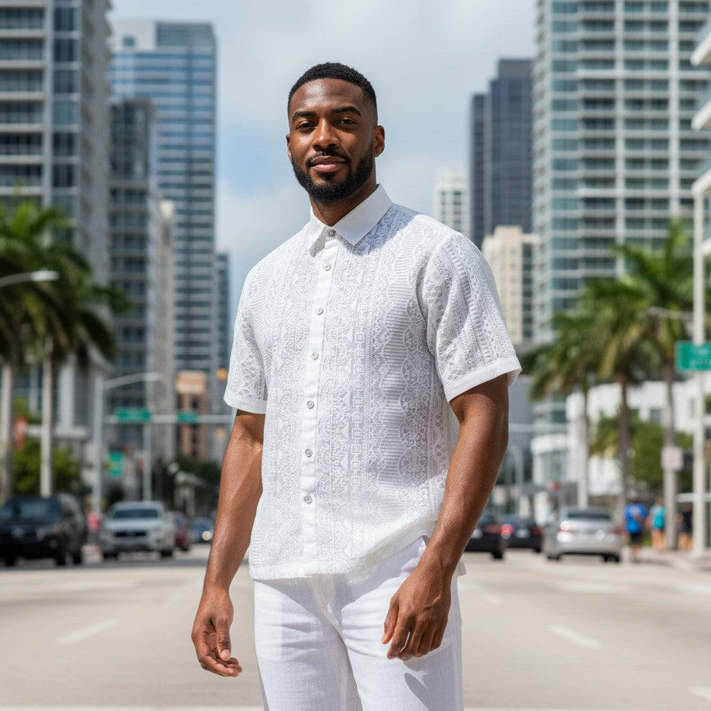 Man wearing a white lace linen short-sleeve shirt and trousers from suit-yourself-menswear in a city street setting.